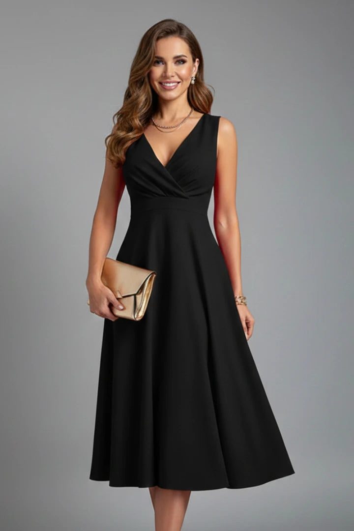 Woman wearing a black v-neck zip closure midi dress - studio photo