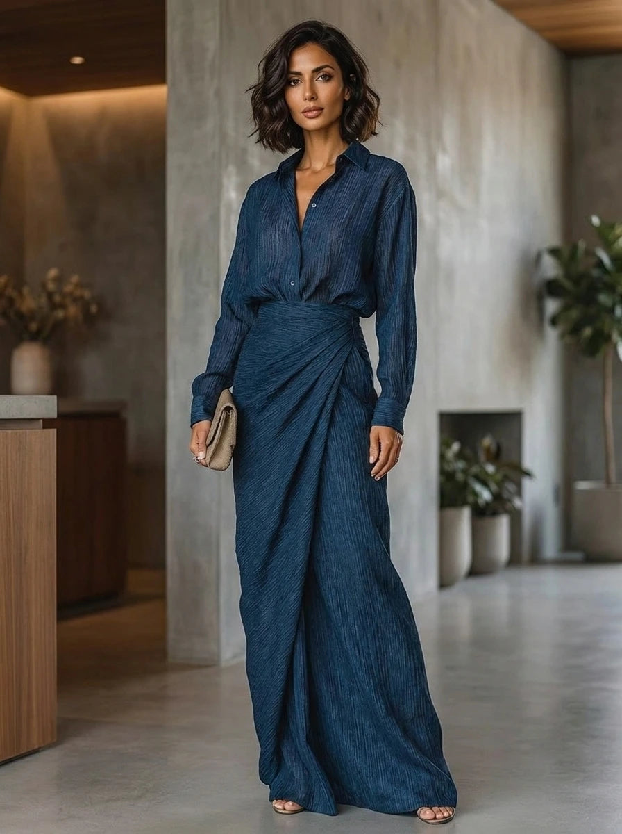 Woman wearing a dark blue elegant long-sleeve wrap maxi dress, indoor setting