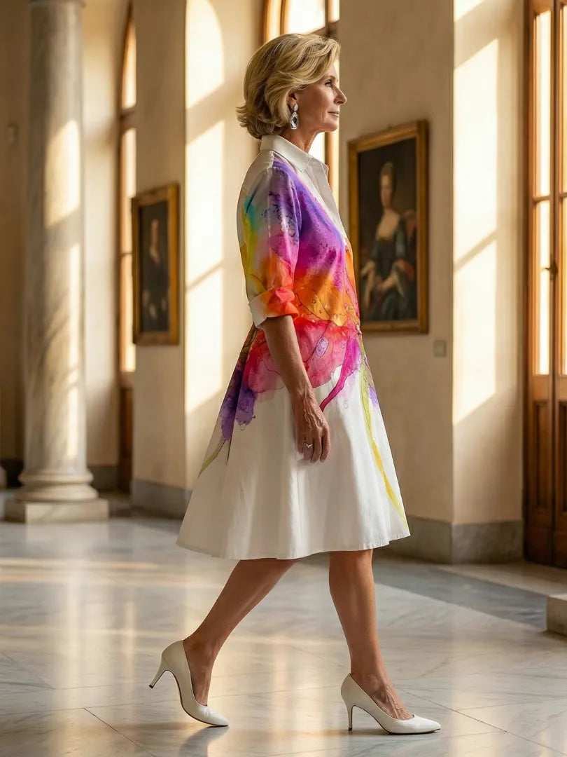 Women's multicolor floral print collared midi dress with three-quarter rolled sleeves and partial button front.