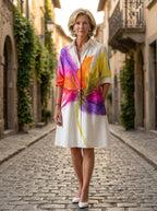 Driftly multicolor floral print collared midi dress with partial button front and rolled cuffs, on a European street at golden hour.