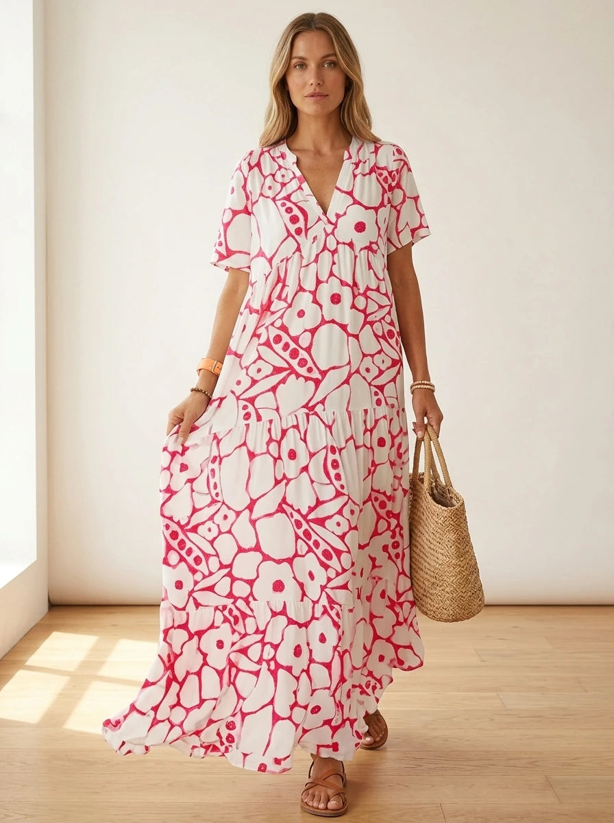 Driftly pink floral V-neck midi dress, bohemian style, soft-blend fabric, in a minimalist studio setting with soft window light.