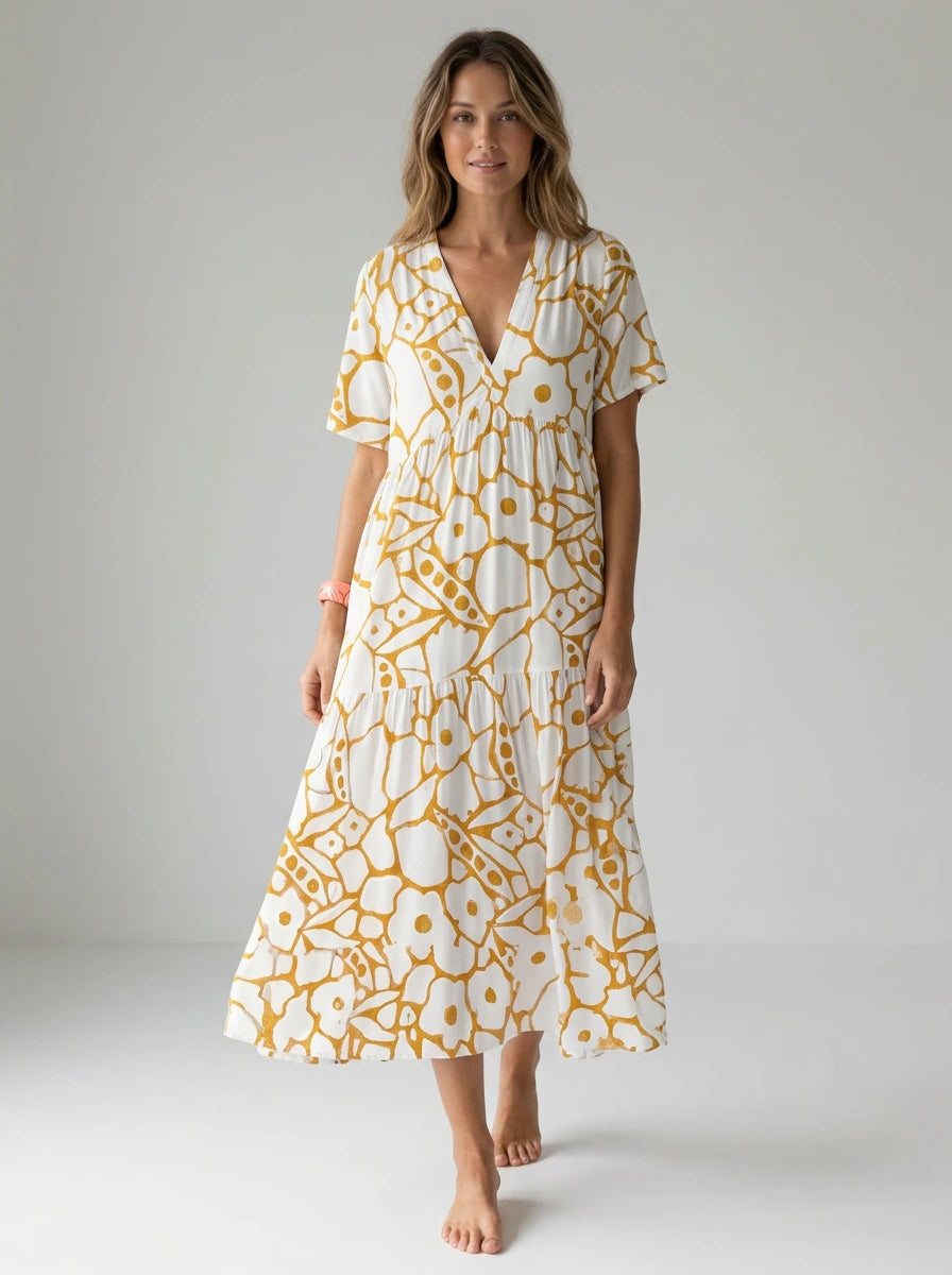Driftly yellow floral V-neck midi dress, bohemian style, soft-blend fabric, in a minimalist studio setting with soft window light.