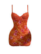 Orange floral lace backless mini dress with spaghetti straps and high-waisted silhouette.
