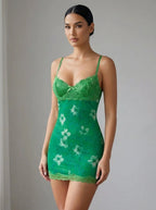 Driftly women's green floral lace backless mini dress with spaghetti straps, in a minimalist studio setting.