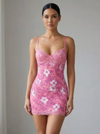 Driftly women's pink floral lace backless mini dress with spaghetti straps, in a minimalist studio setting.