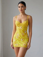Driftly women's yellow floral lace backless mini dress with spaghetti straps, in a minimalist studio setting.