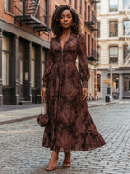 Woman wearing a brown paisley print fitted maxi dress, urban street setting
