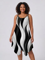 Plus size woman wearing a black and white geometric print asymmetrical dress in a studio setting