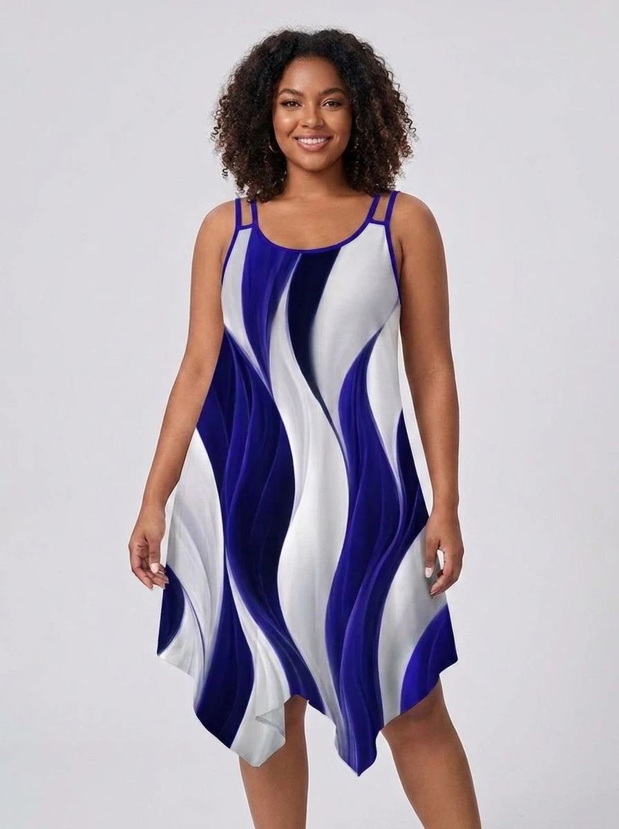 Plus size woman wearing a blue and white geometric print asymmetrical dress in a studio setting