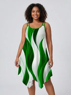 Plus size woman wearing a green and white geometric print asymmetrical dress in a studio setting