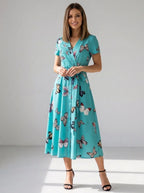 Driftly women's turquoise blue butterfly print V-neck A-line maxi dress, in a minimalist studio setting.