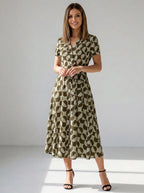 Driftly women's khaki geometric print V-neck A-line maxi dress, in a minimalist studio setting.