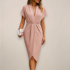 Woman wearing a pink wrap midi dress - studio photo