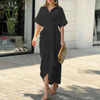 Woman wearing a black wrap short sleeve midi dress - outdoor lifestyle photo