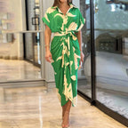 Woman wearing a green wrap short sleeve midi dress - outdoor lifestyle photo