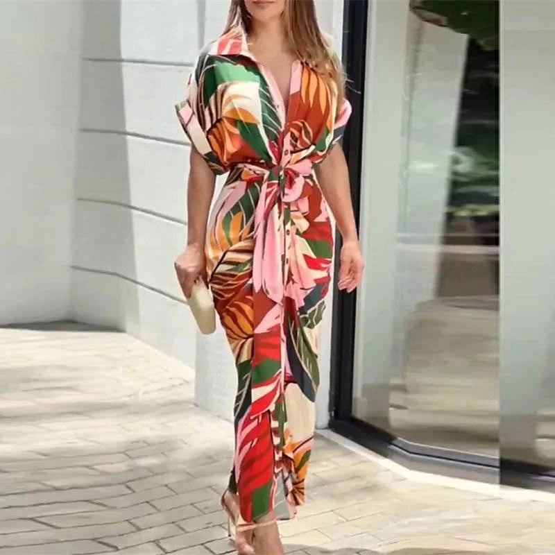 Woman wearing a multi color wrap short sleeve midi dress - outdoor lifestyle photo