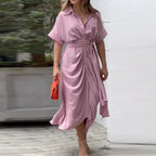 Woman wearing a pink wrap short sleeve midi dress - outdoor lifestyle photo