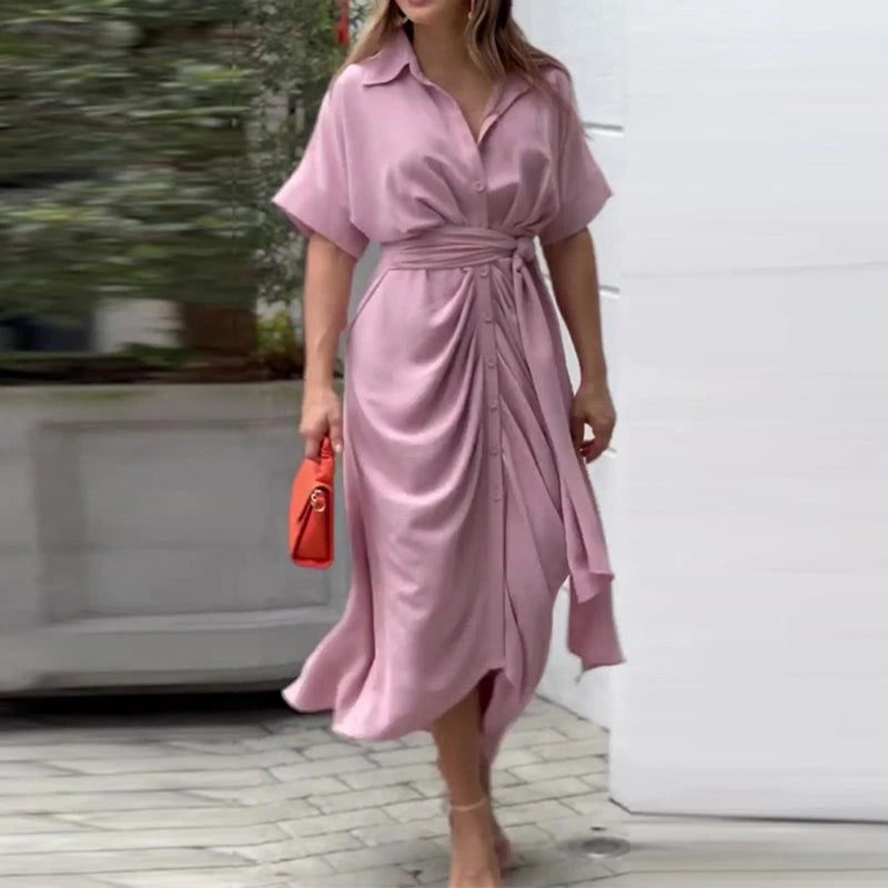 Woman wearing a pink wrap short sleeve midi dress - outdoor lifestyle photo