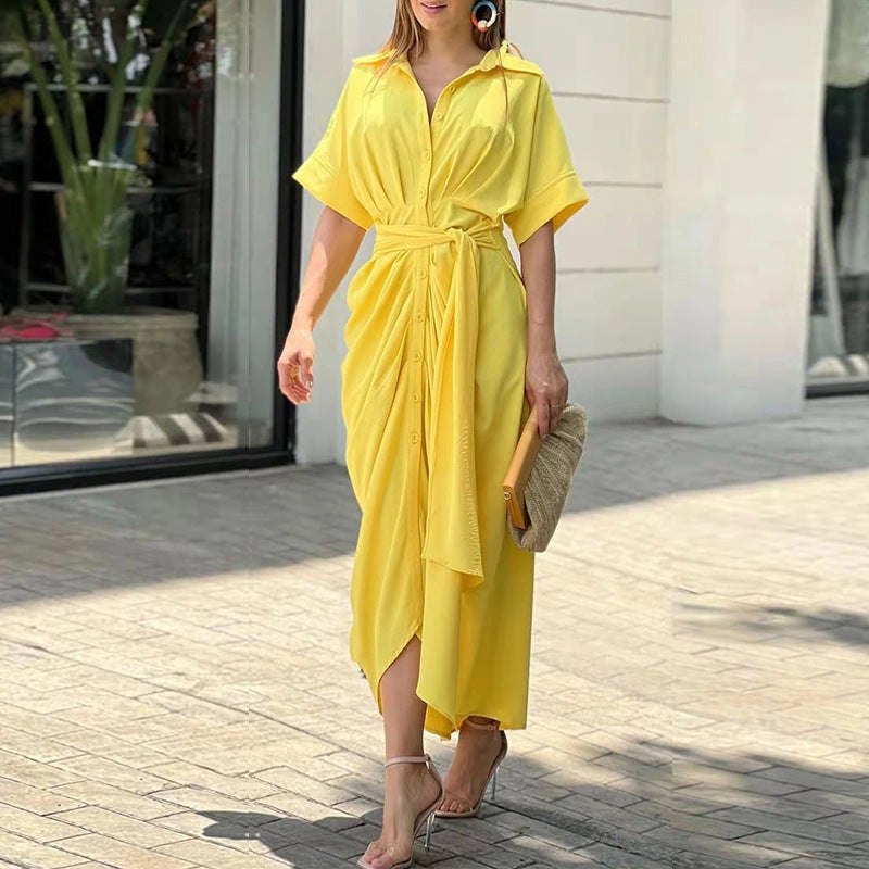 Woman wearing a yellow wrap short sleeve midi dress - outdoor lifestyle photo