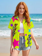 Woman wearing a neon yellow printed button-up shirt on a sunny beach