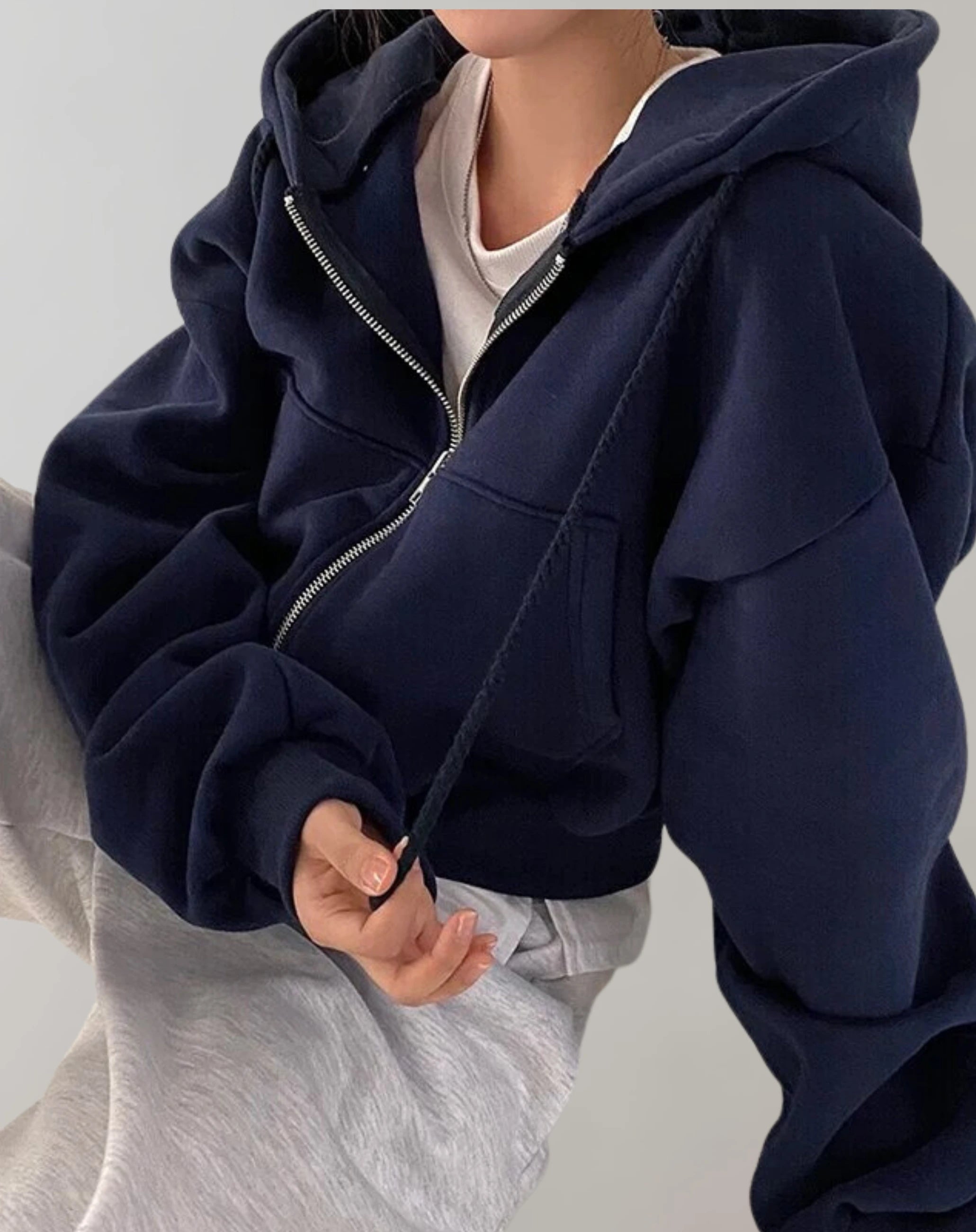 Driftly zip-up hoodie in navy black, worn by model