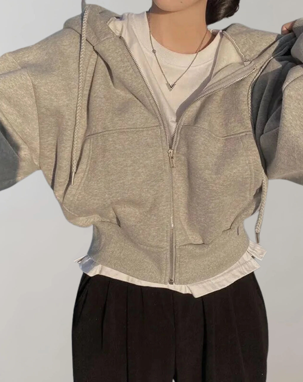 Driftly zip-up hoodie in light taupe grey, worn by model