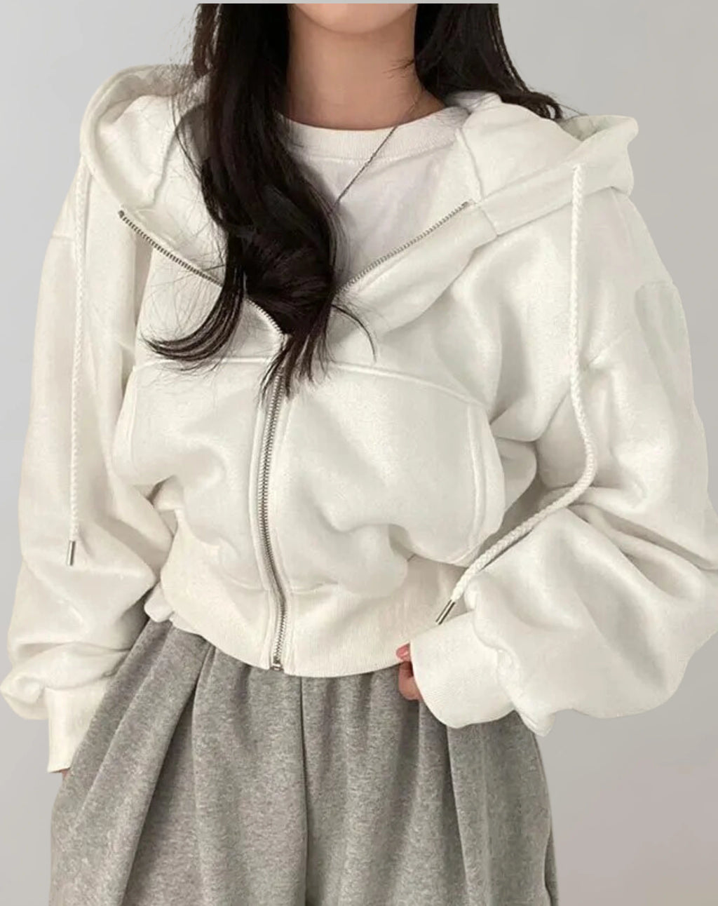 Driftly zip-up hoodie in white, worn by model