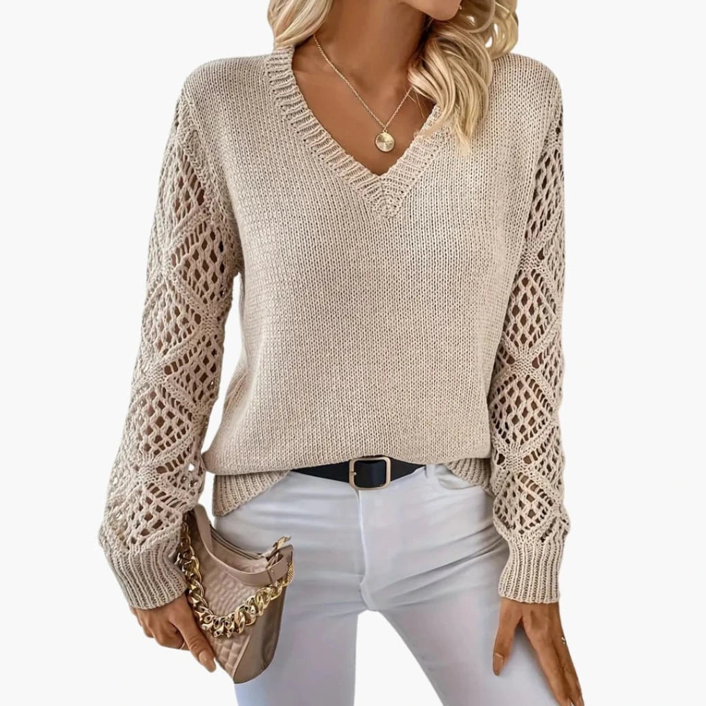 Woman wearing beige knitted V-neck jumper with open sleeve detail