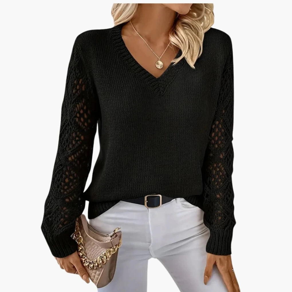 Woman wearing black knitted V-neck jumper with open sleeve detail