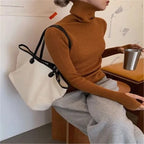 Woman wearing brown ribbed turtleneck slim fit jumper