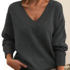Woman wearing dark grey deep V-neck cashmere-feel knit jumper