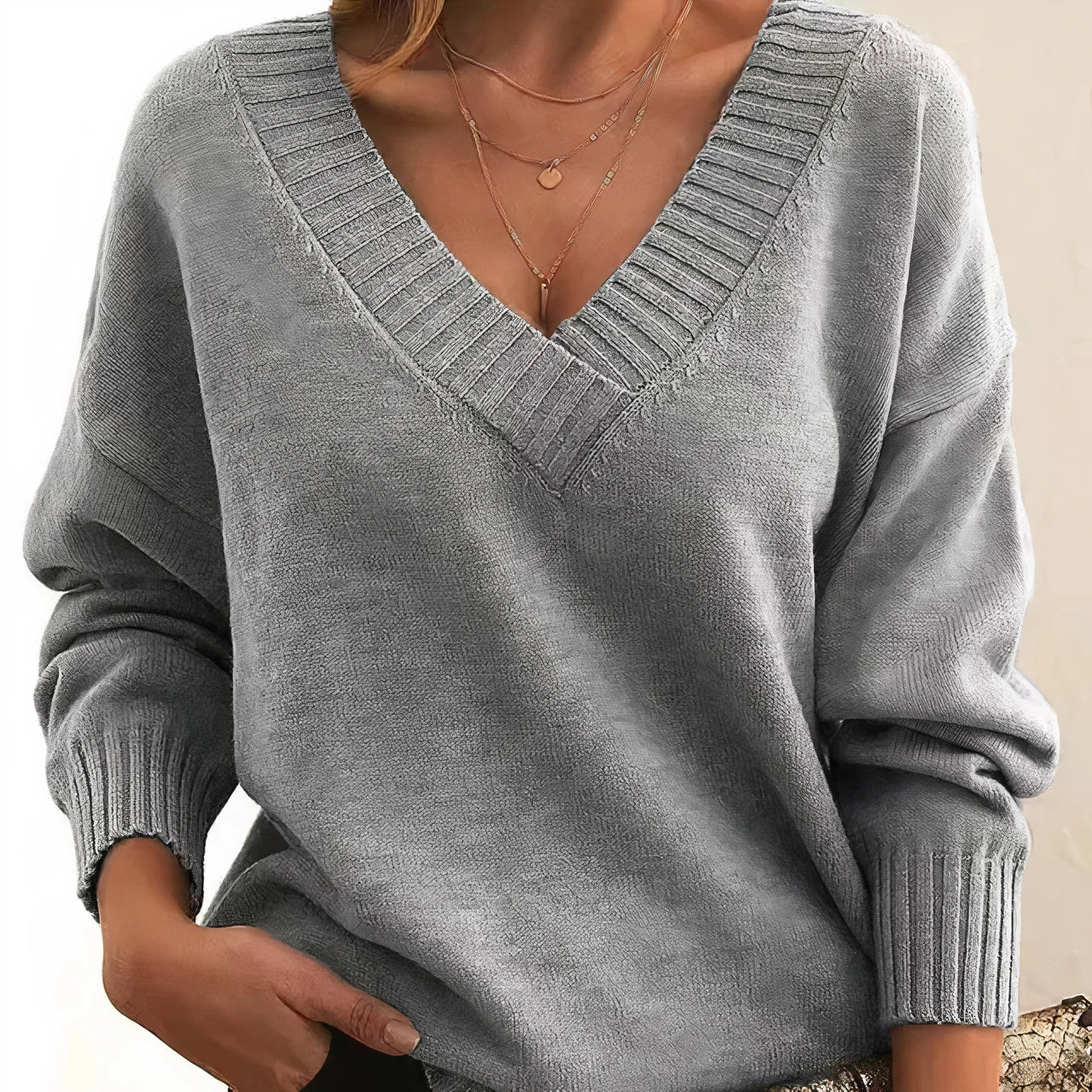 Woman wearing grey deep V-neck cashmere-feel knit jumper