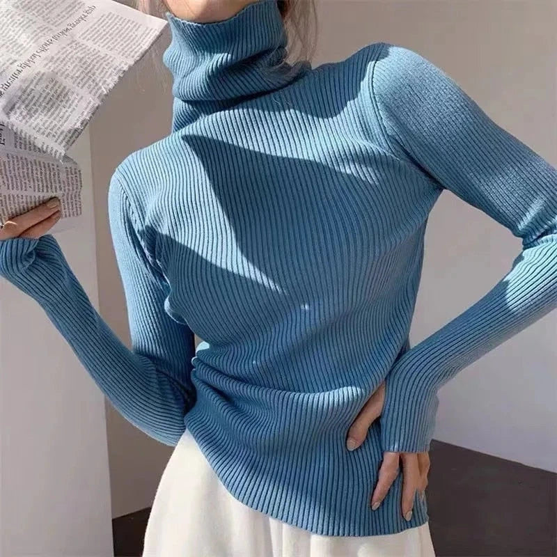 Woman wearing light blue ribbed turtleneck slim fit jumper