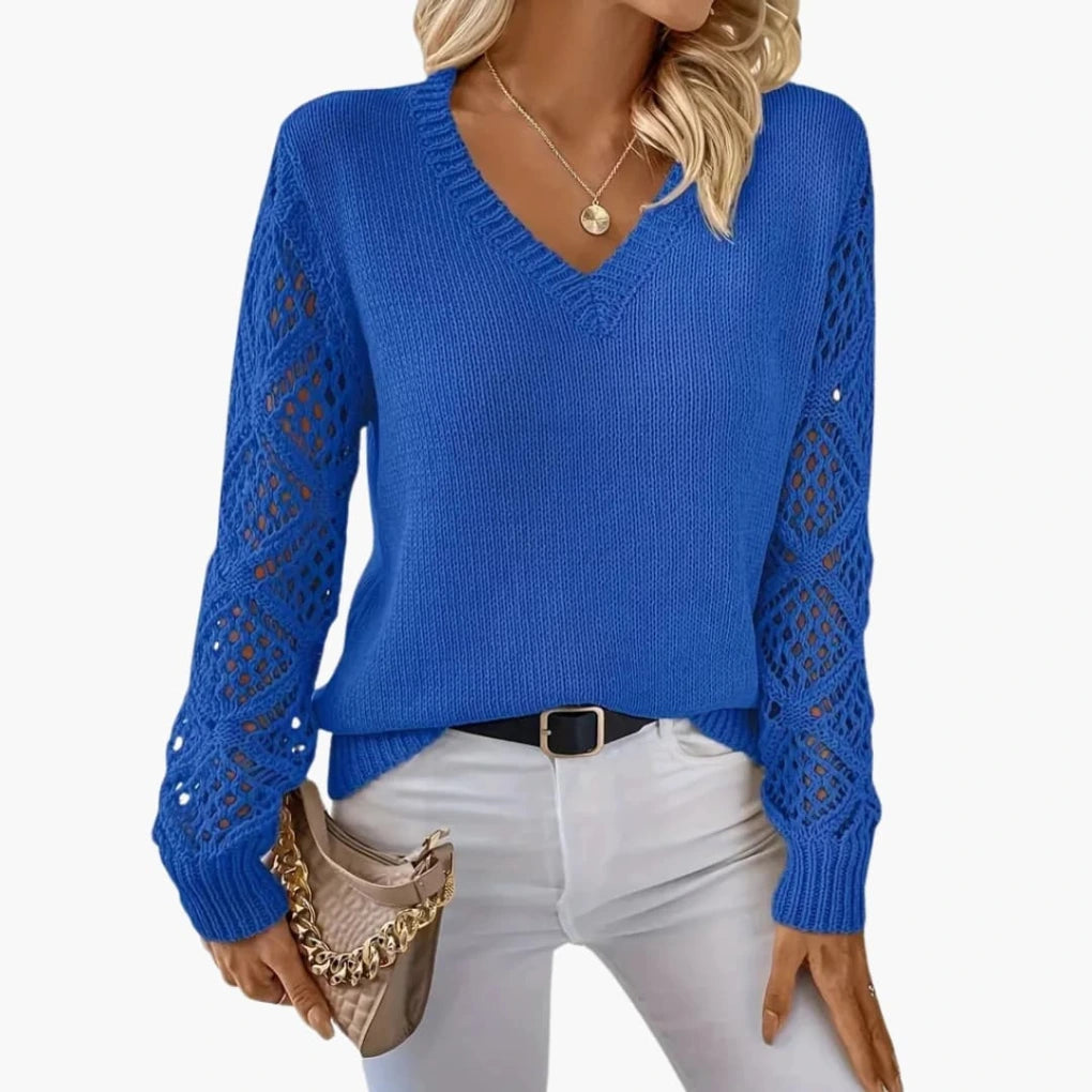 Woman wearing royal blue knitted V-neck jumper with open sleeve detail