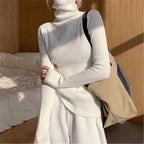Woman wearing white ribbed turtleneck slim fit jumper