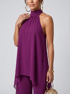 Woman wearing a purple asymmetric tunic wide-leg set - studio photo