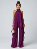 Woman wearing a purple asymmetric tunic wide-leg set - studio photo