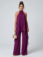 Woman wearing a purple asymmetric tunic wide-leg set - studio photo