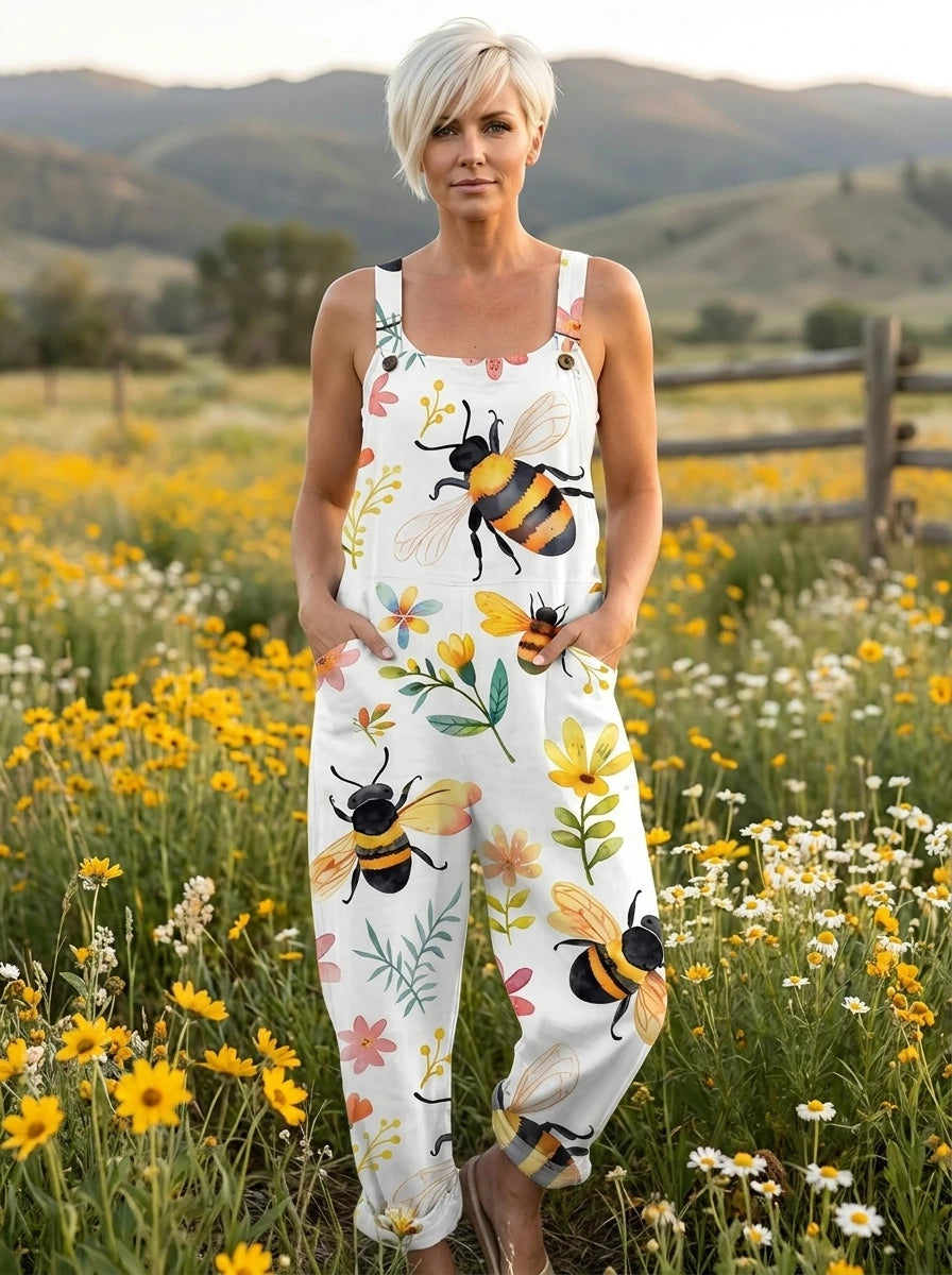 Woman wearing a white jumpsuit with a bee and floral blossom print in a flower field