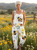 Woman wearing a white jumpsuit with a bee and floral blossom print in a flower field
