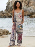 Woman wearing a bee print wide-leg jumpsuit on a beach