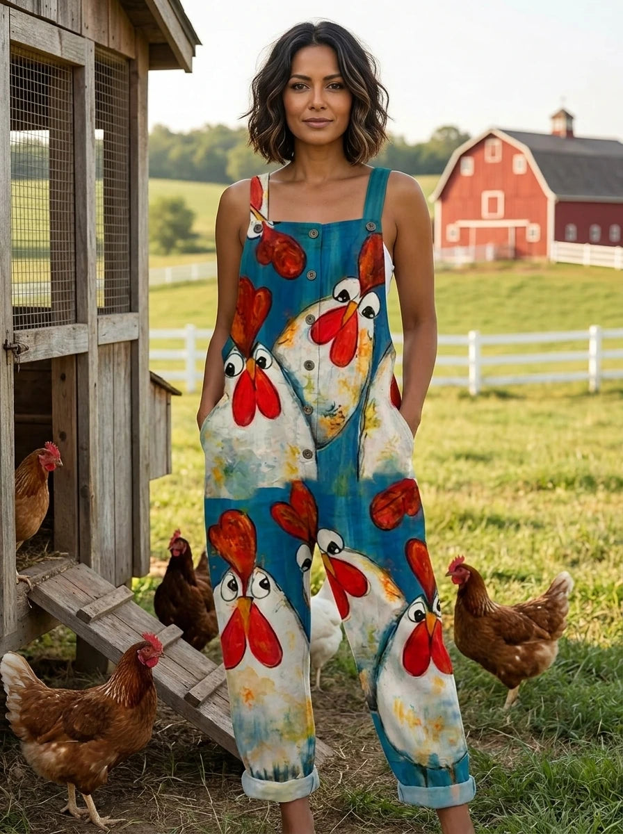 Woman wearing a teal chicken print sleeveless button-front overall jumpsuit standing in a farm setting