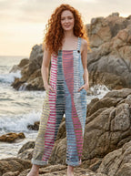 Woman wearing a coastal rhythm print jumpsuit on a beach