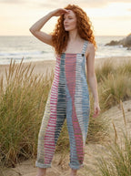 Woman standing near beach dunes wearing a coastal rhythm print jumpsuit