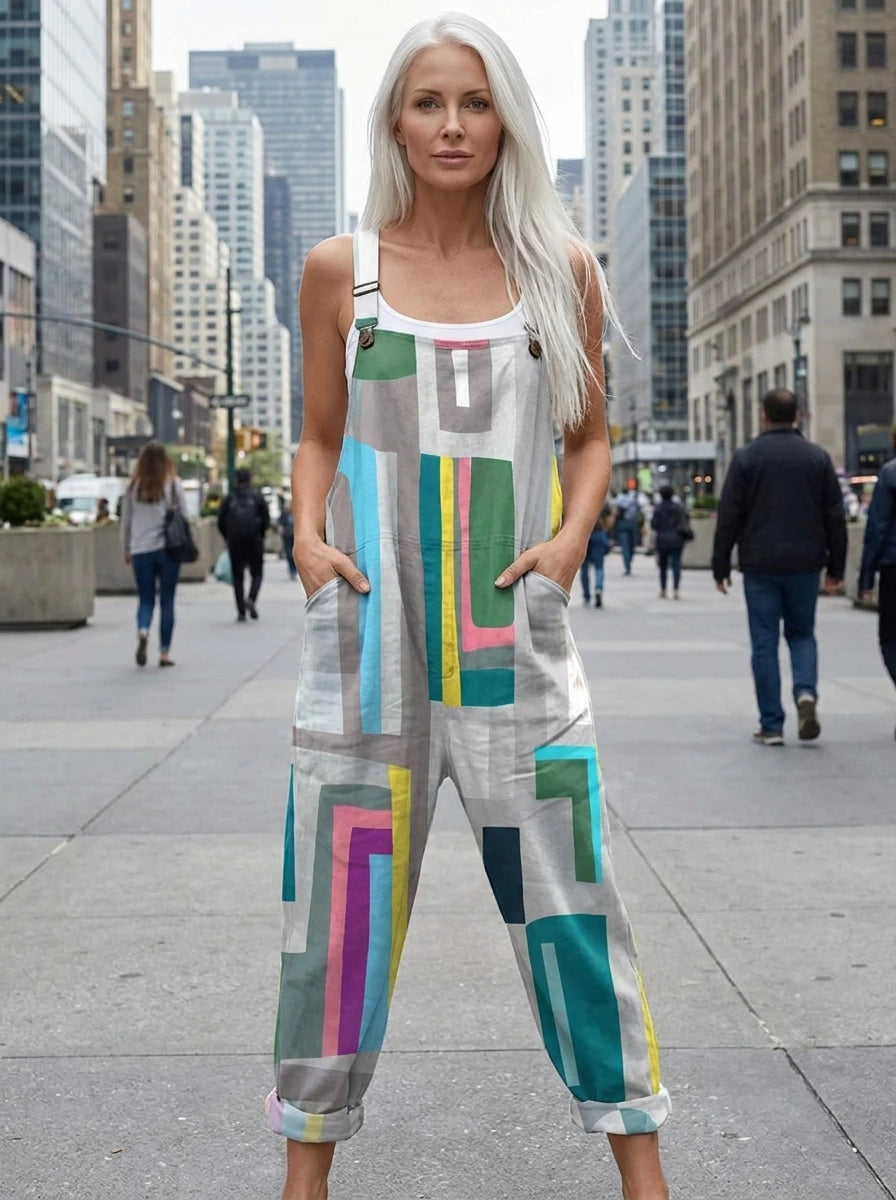 Woman wearing a grey multicolor geometric color-block wide-leg overall jumpsuit standing on an urban street