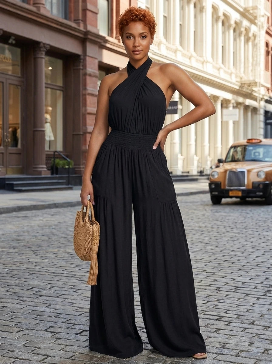 Woman wearing a black cross halter wide-leg jumpsuit on a city street