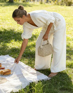 Woman wearing a white elegant wide-leg jumpsuit - lifestyle photo