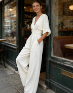 Woman wearing a white elegant wide-leg jumpsuit - lifestyle photo