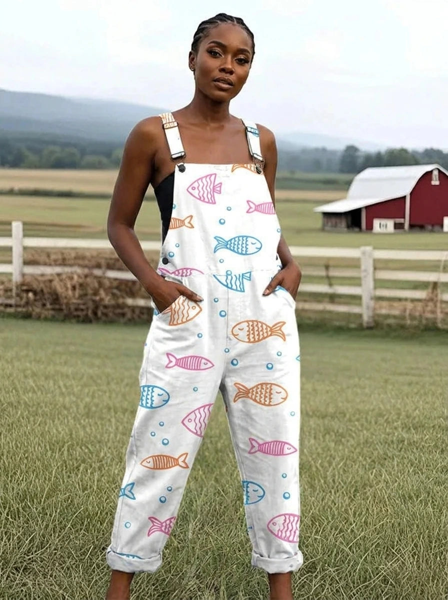 Woman wearing a white jumpsuit with a colorful fish print on a farm