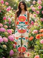Woman in a cream floral bloom print jumpsuit walking along a garden path